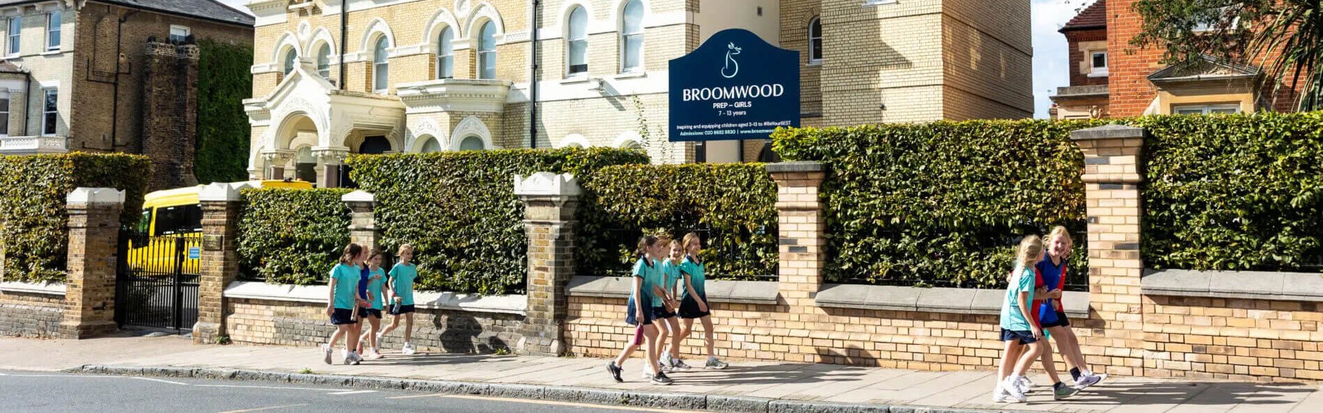 Students walking outside the front of Broomwood School