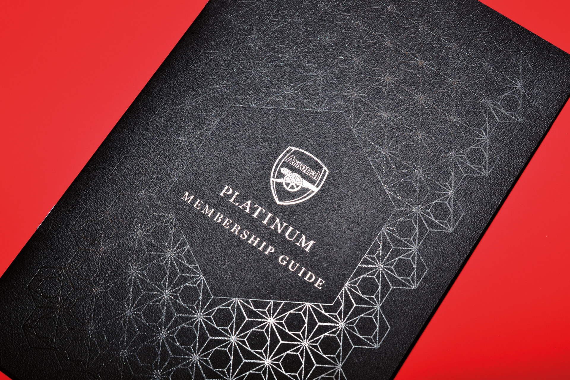 Arsenal FC platinum membership brochure showcasing the spot uv pattern work on the cover