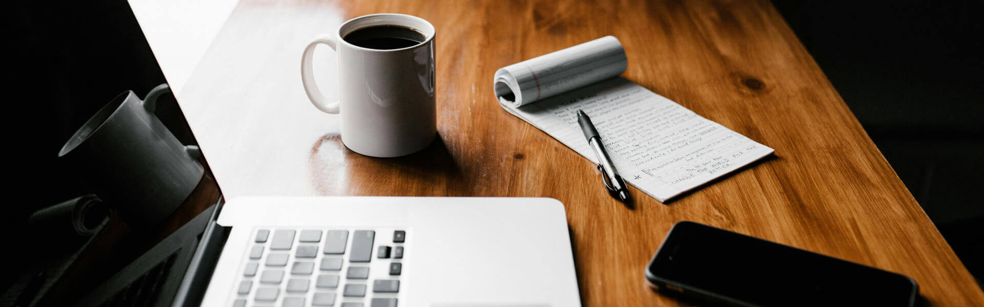andrew-neel-cckf4TsHAuw-unsplash Laptop, notepad and coffee cup on a table