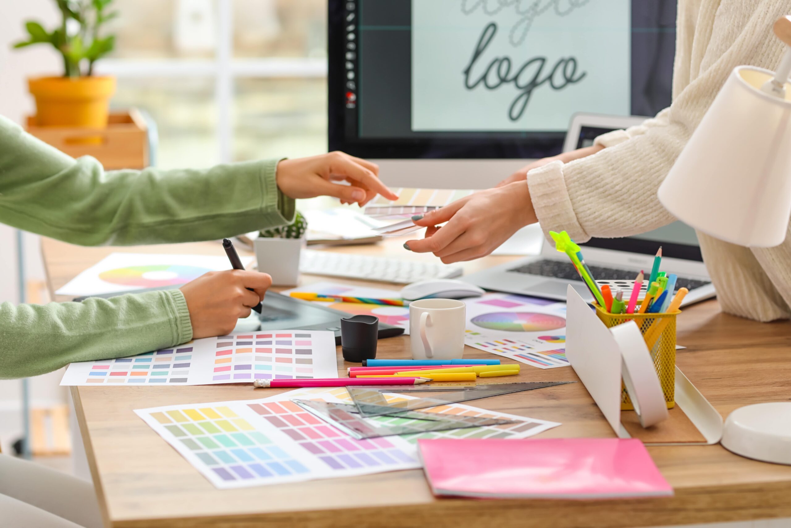 Stock imagery of a designer collaborating Graphic designer collaborating with clients on a design project