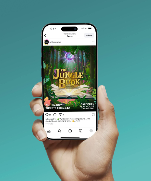 Jungle Book Instagram 500x600px A hand holding a phone showing an Instagram feed. The feed shows a social post from Wiltshire creative promoting their jungle book show at the Salisbury Playhouse 23-26 July with tickets from £12. Image is mocked up on a turquoise background.