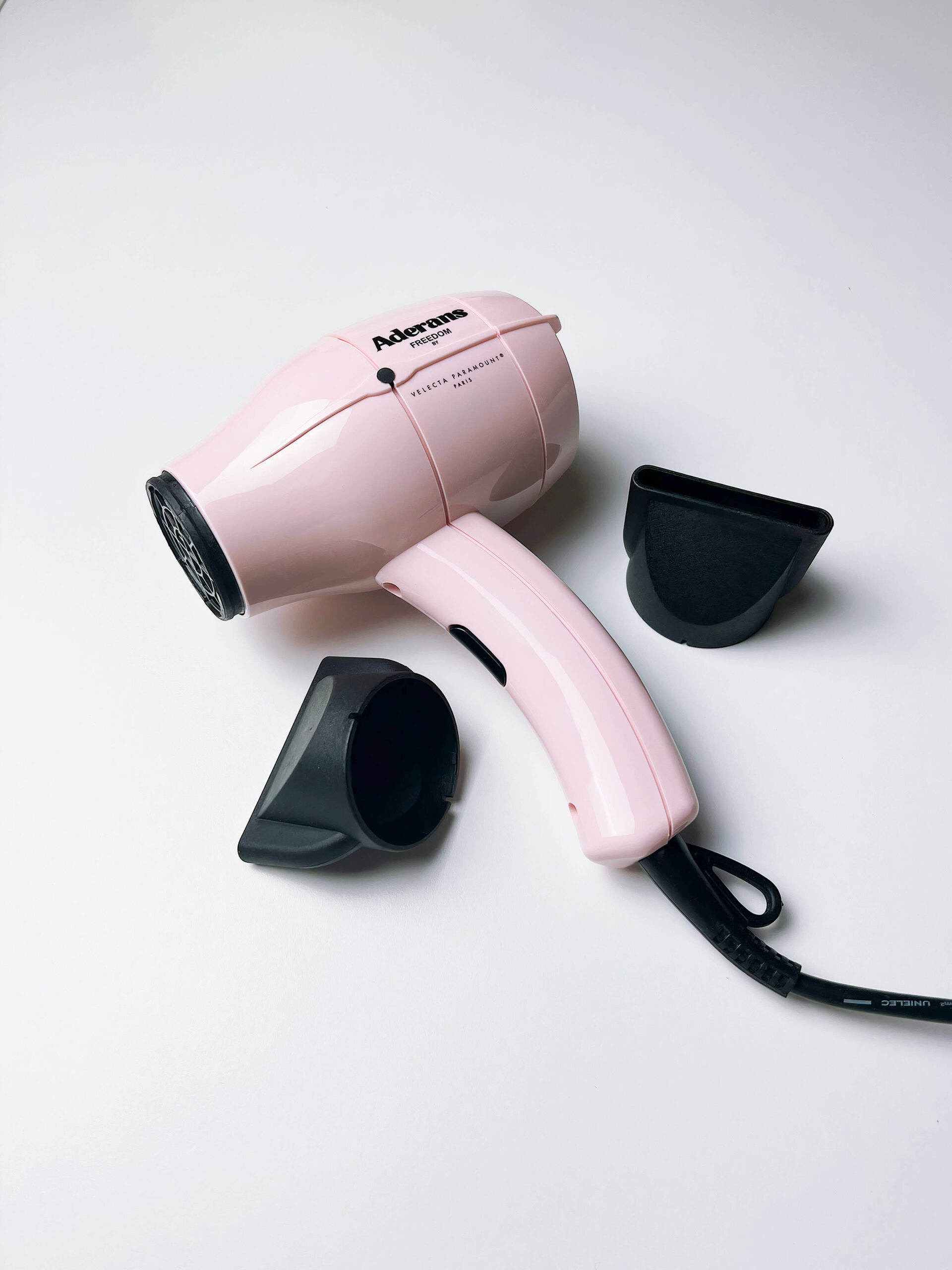 Aderans Hairdryer_LE_auto_x2 A roll of stickers with the circomedia logo on them mocked-up on a light background