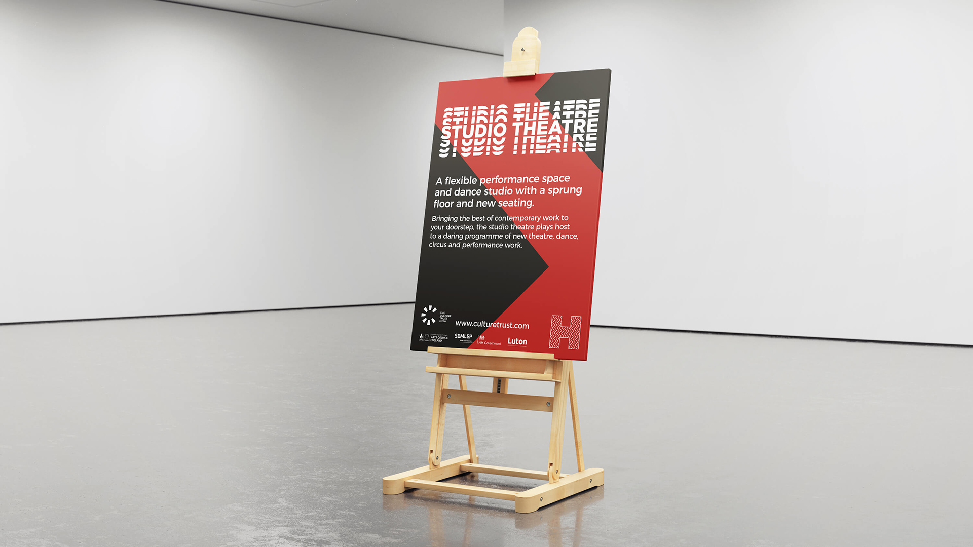 An image of a poster from the hat factory relaunch poster on an easel.