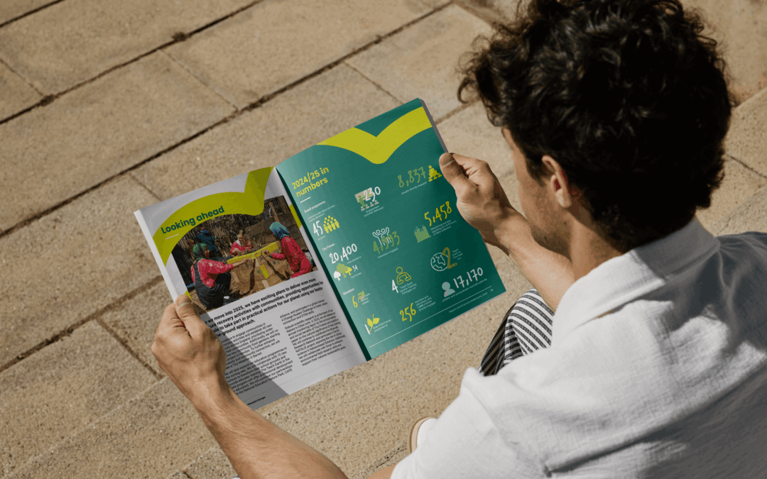 A mock-up of a man sat reading the Earthwatch annual report.