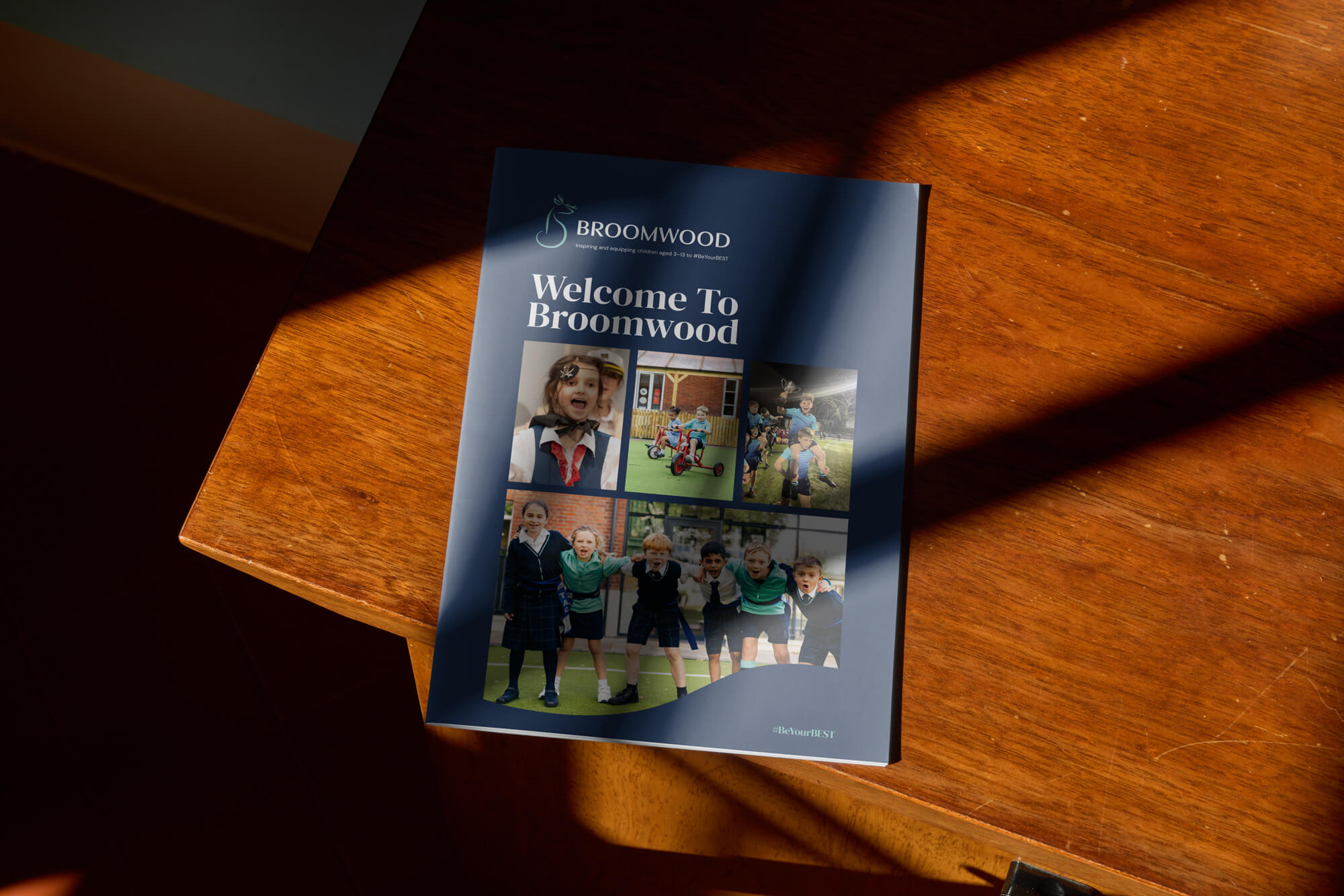 A mock-up of the broomwood prospectus on a table showing the front cover.