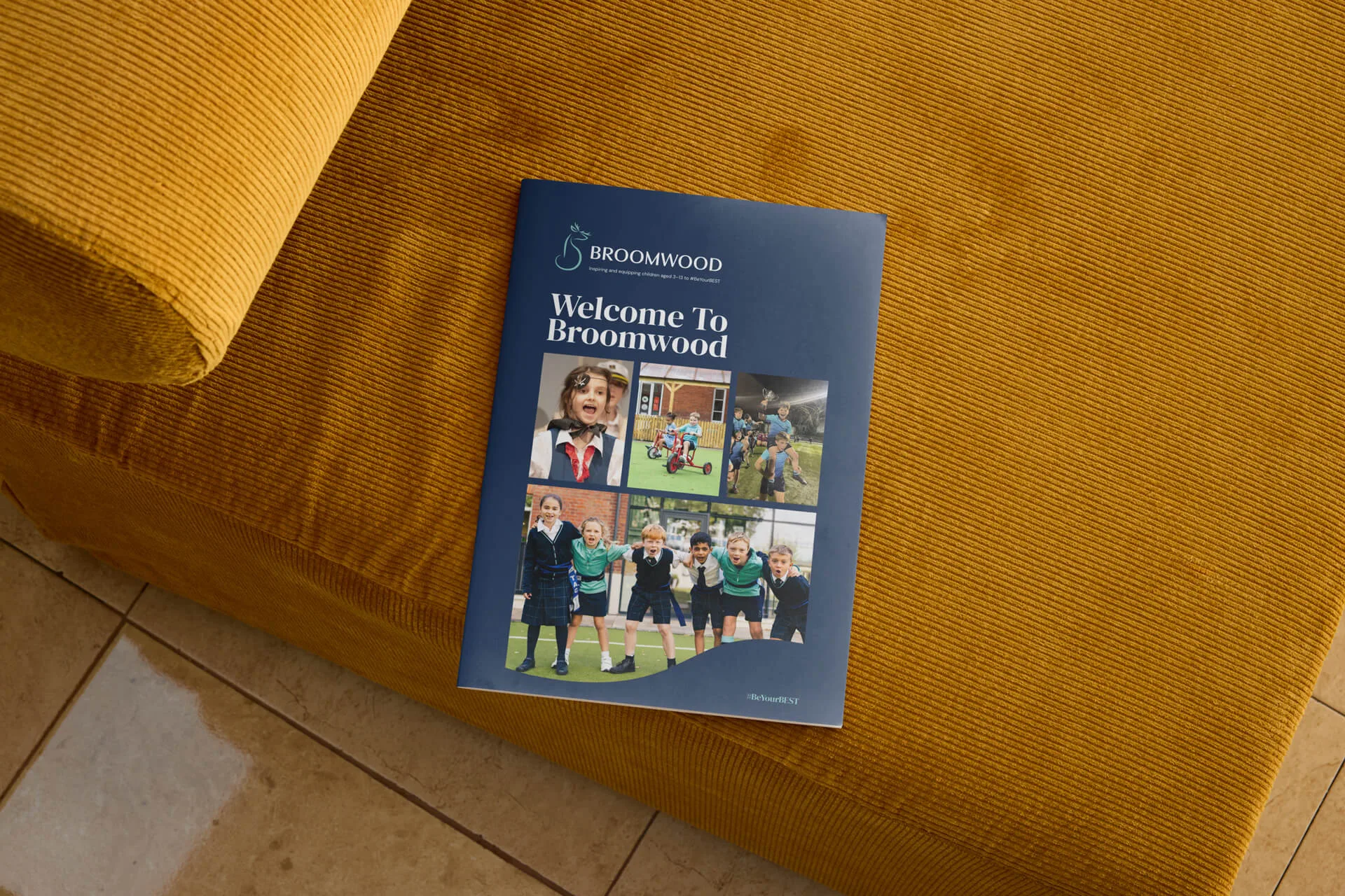 A mock-up of the Broomwood School Prospectus cover on a chair.